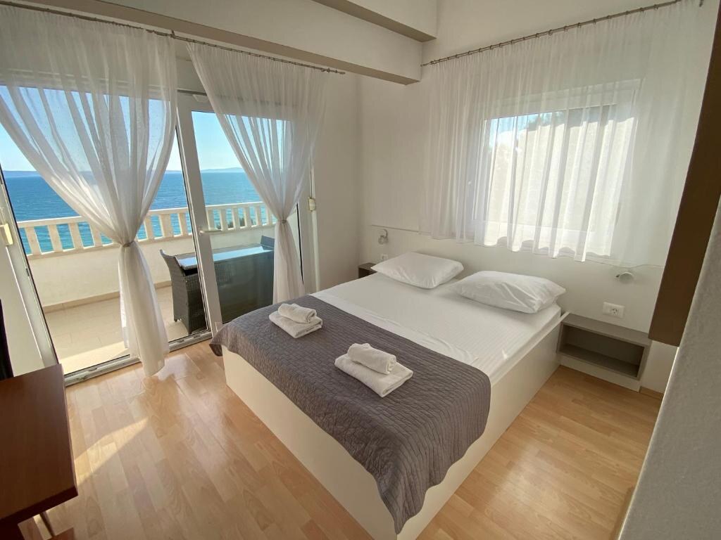 Bedroom with balcony doors opening to the sea